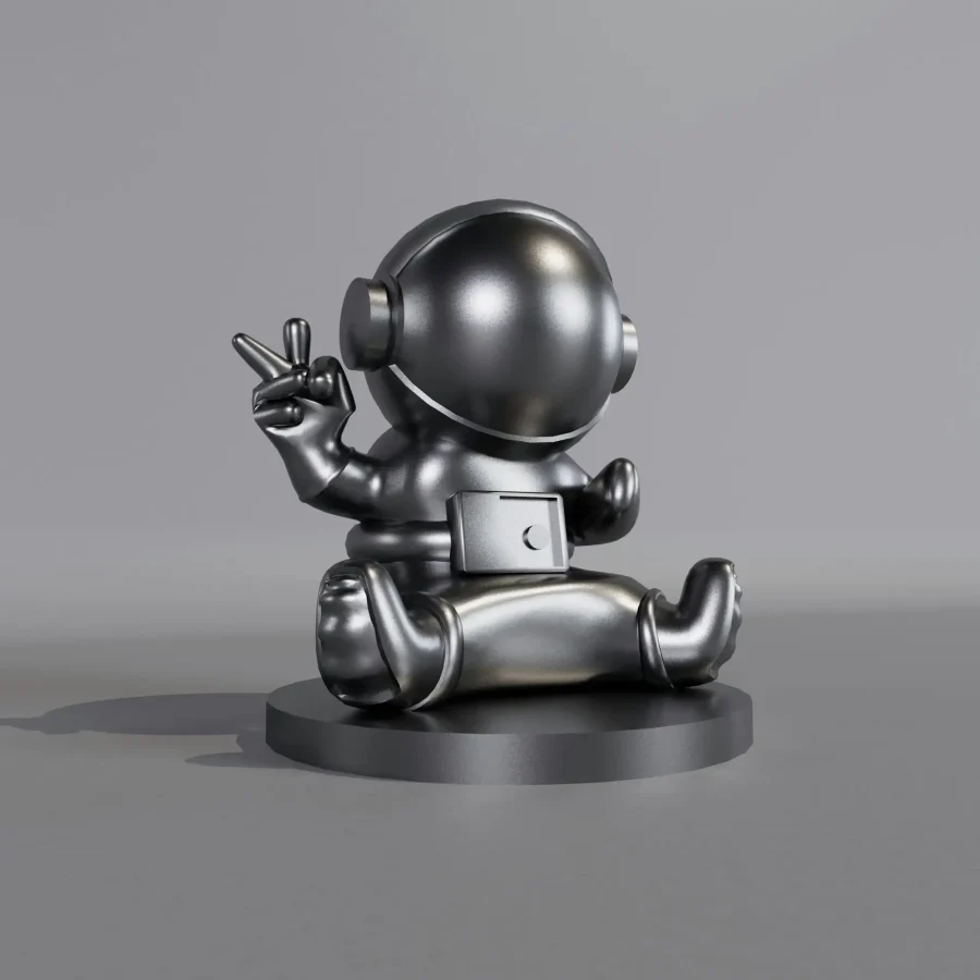 A shiny metallic astronaut figurine presenting a peace sign, symbolizing space exploration.